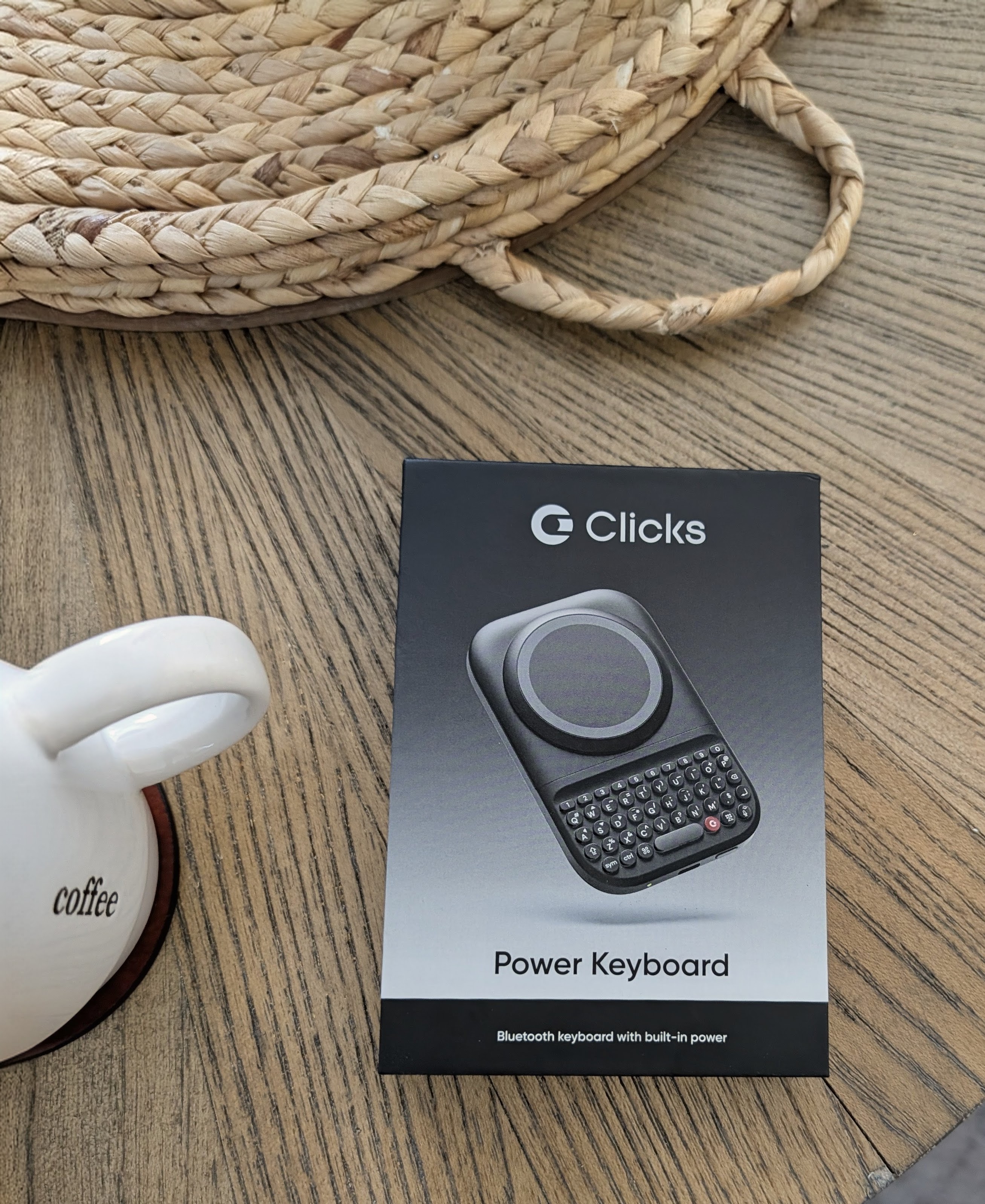 top down shot of the clicks power keyboard box next to a coffee mug